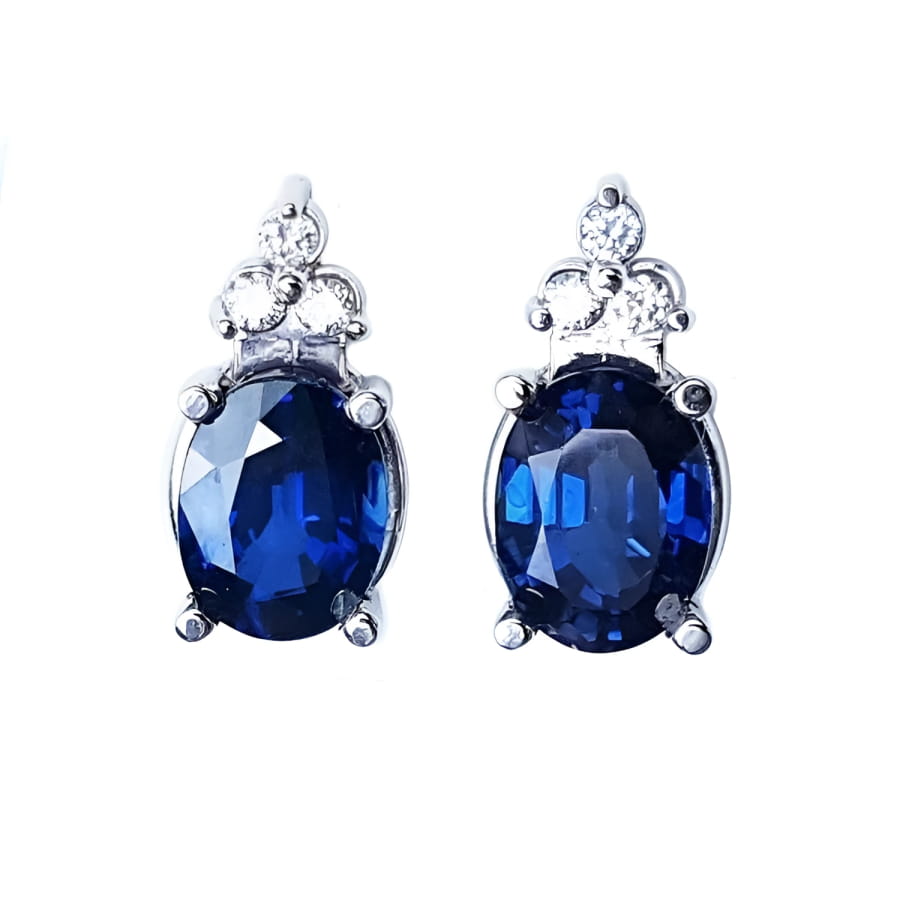 Natural blue sapphire earrings oval cut stud diamonds white gold, topped with three prong-set natural diamonds.