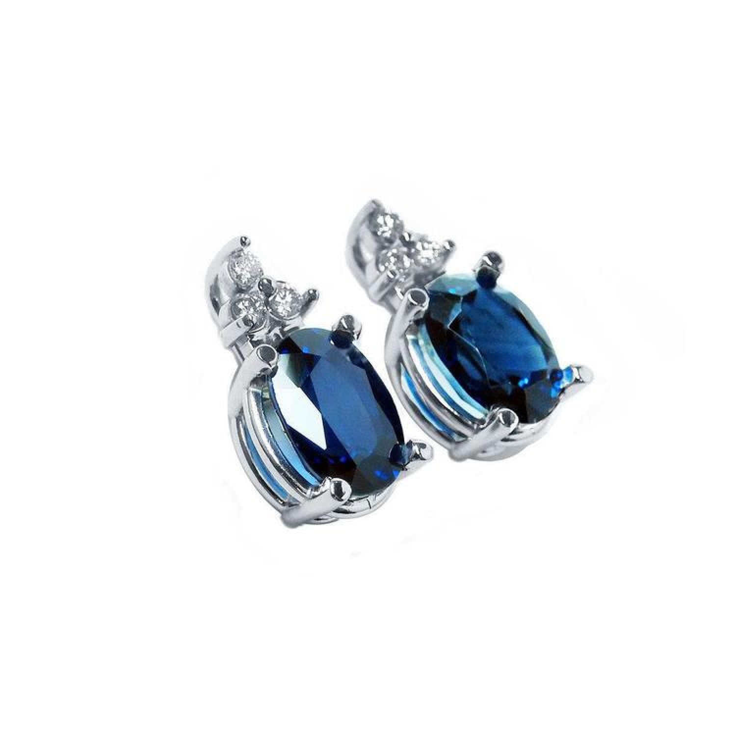 Oval natural blue sapphire stud earrings with three prong-set diamonds in 14K white gold.
