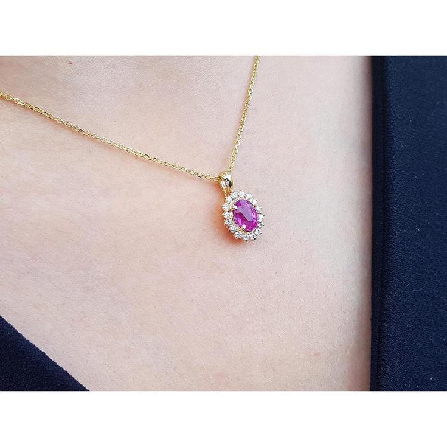 Oval pink sapphire halo diamond pendant necklace in 14K yellow gold.