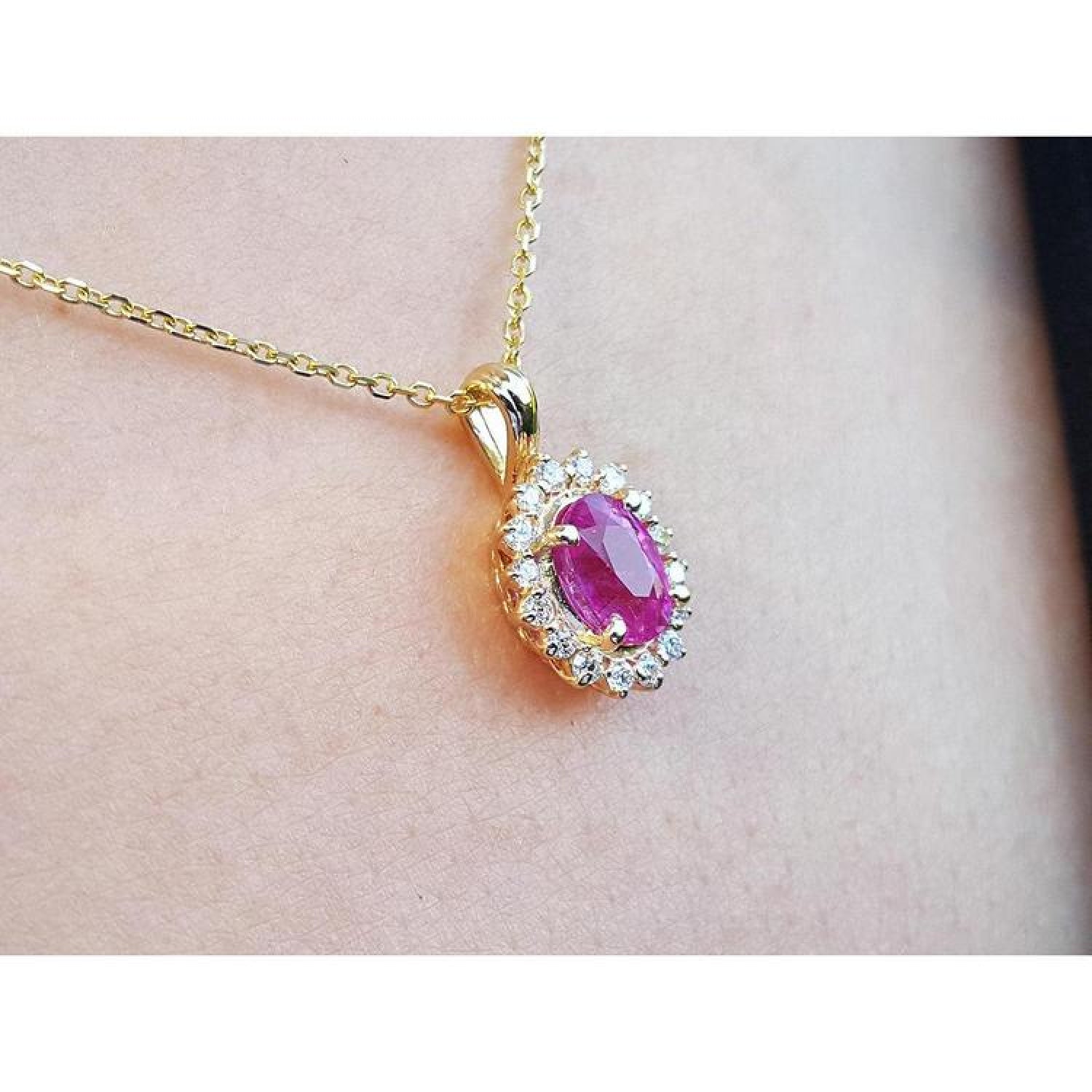 Oval pink sapphire halo diamond necklace pendant in 14K yellow gold.