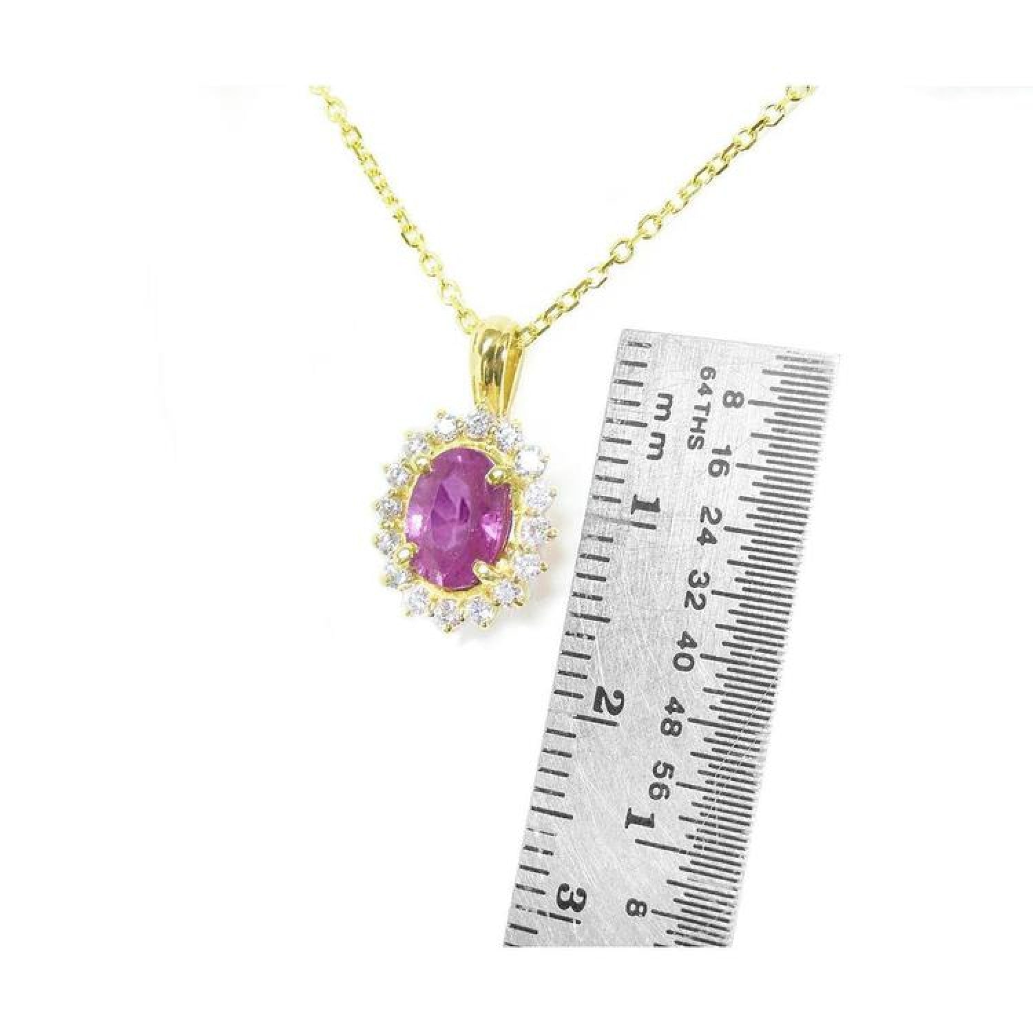 14K yellow gold necklace with oval pink sapphire halo diamond pendant, next to a ruler.