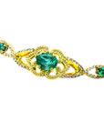 Gold bracelet with natural emeralds on a white background.