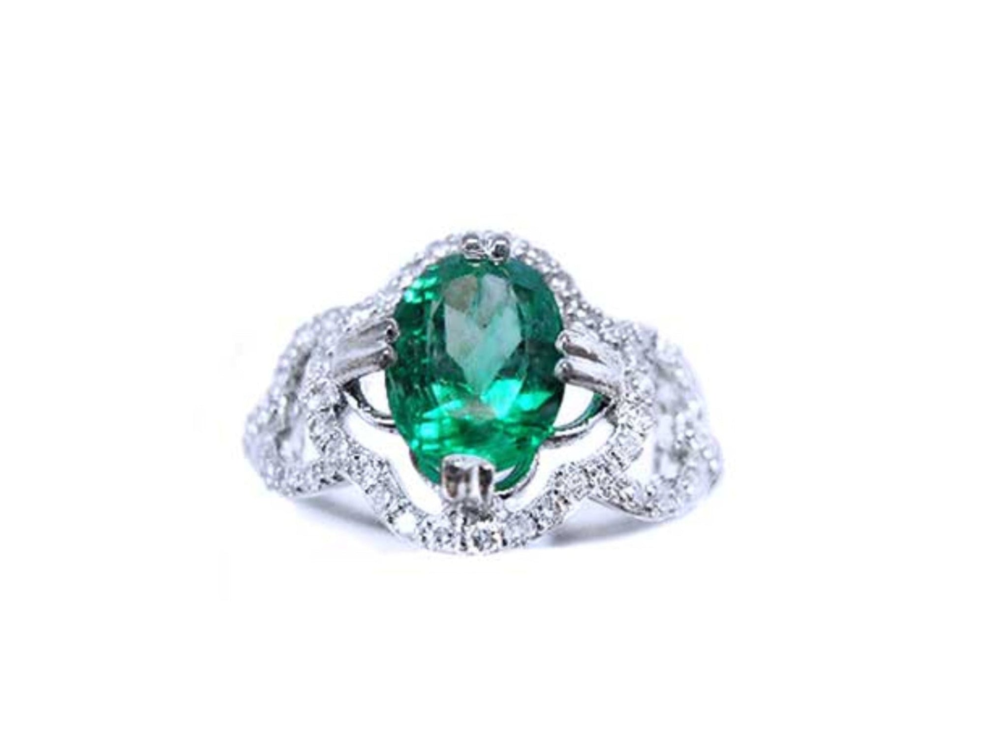 This oval-cut emerald, elegantly set at the heart of a four-leaf clover design framed by a halo of diamonds is in 14K gold.