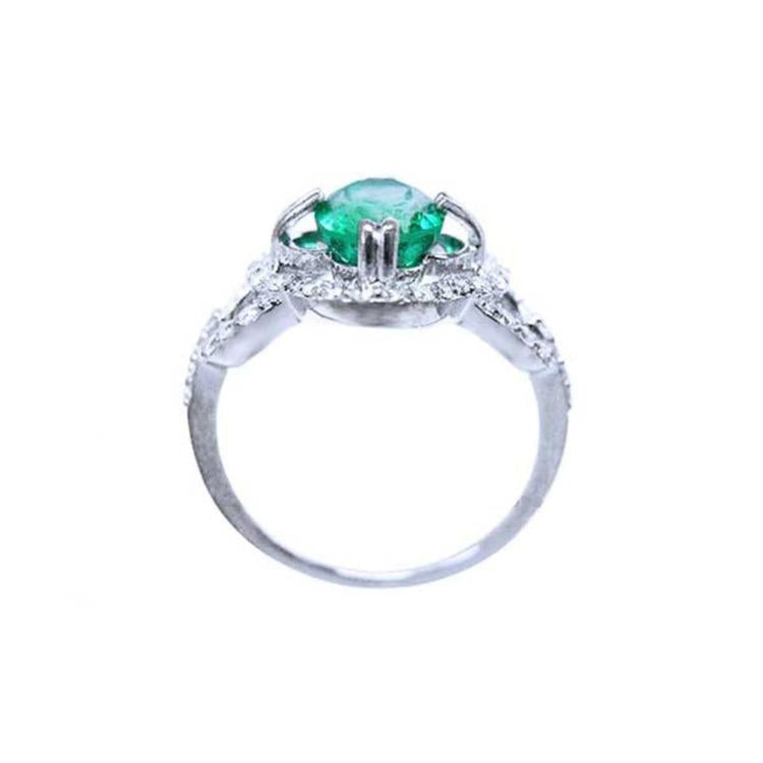 1.55 ct oval emerald clover ring with diamond halo in 14K white gold.