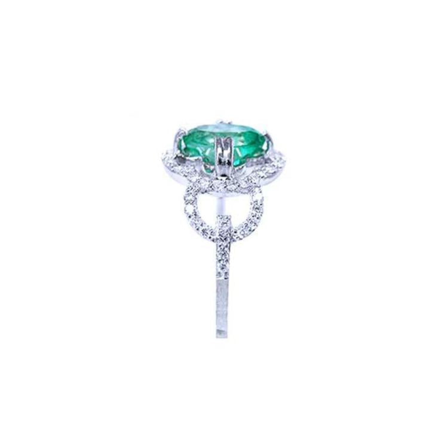 1.55 ct. oval emerald clover ring with diamond halo in 14K white gold.
