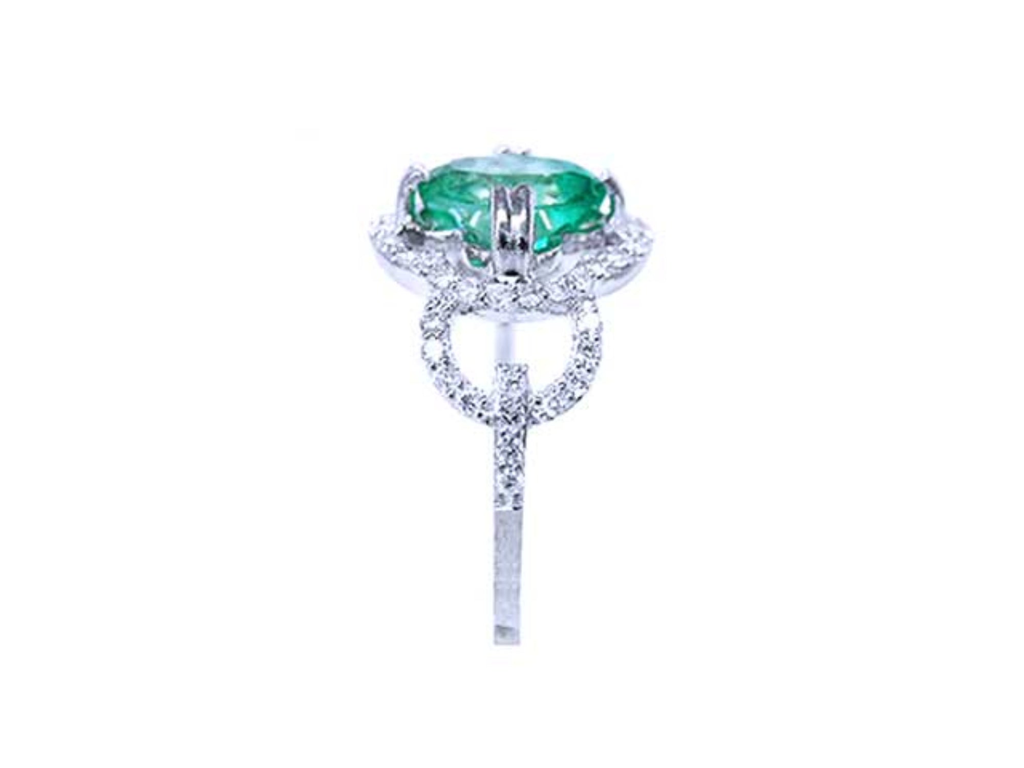 A clean side profile perspective of this natural emerald ring crafted in 14K white gold.