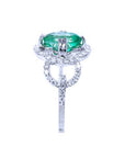 A clean side profile perspective of this natural emerald ring crafted in 14K white gold.