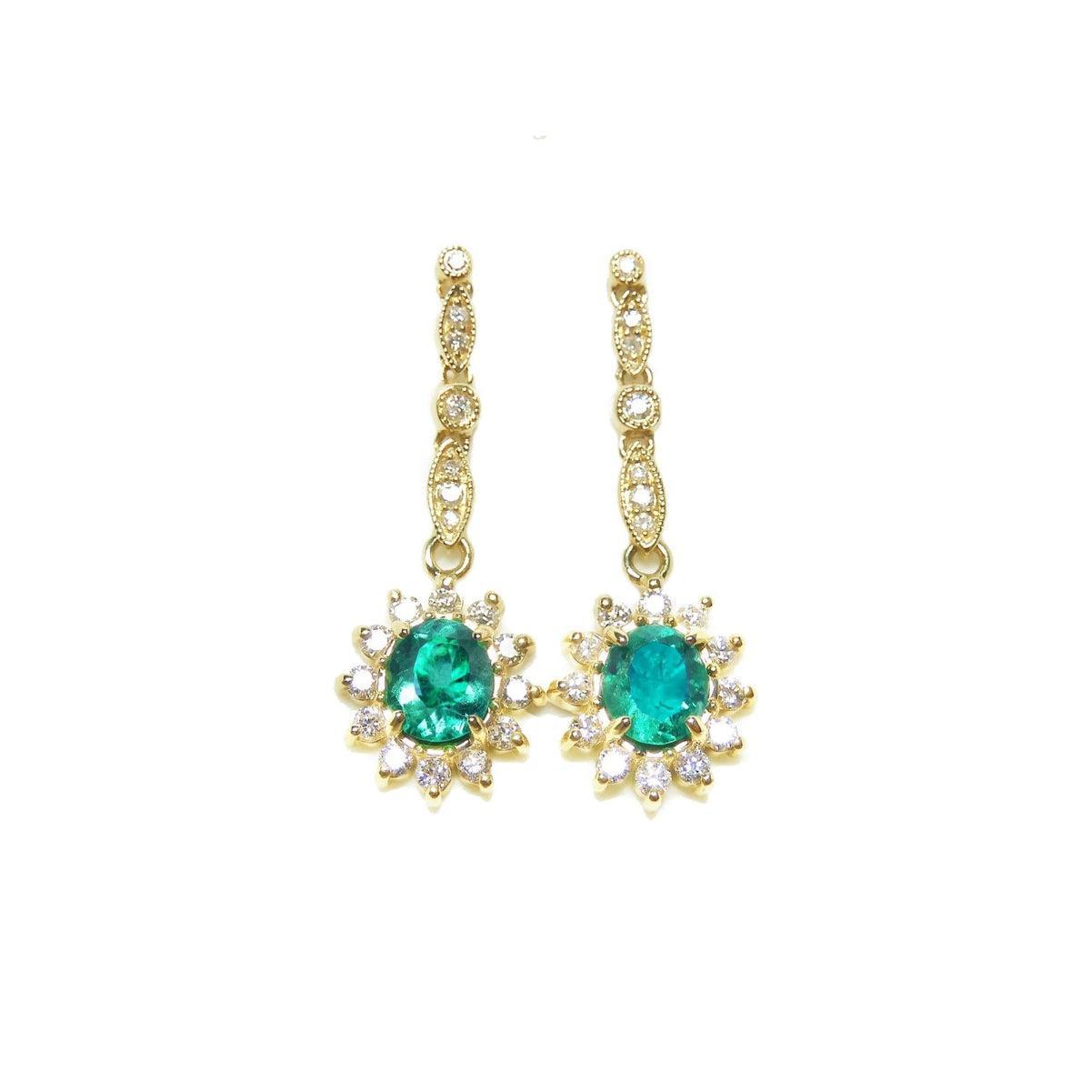 A pair of oval cut emerald halo diamond dangle earrings yellow gold