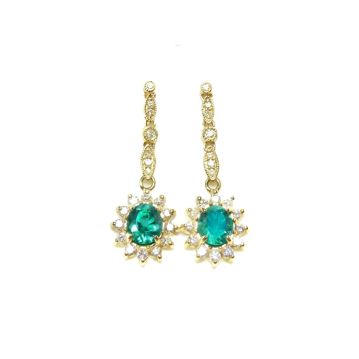 Oval emerald dangle earrings with halo diamonds in 14K yellow gold.