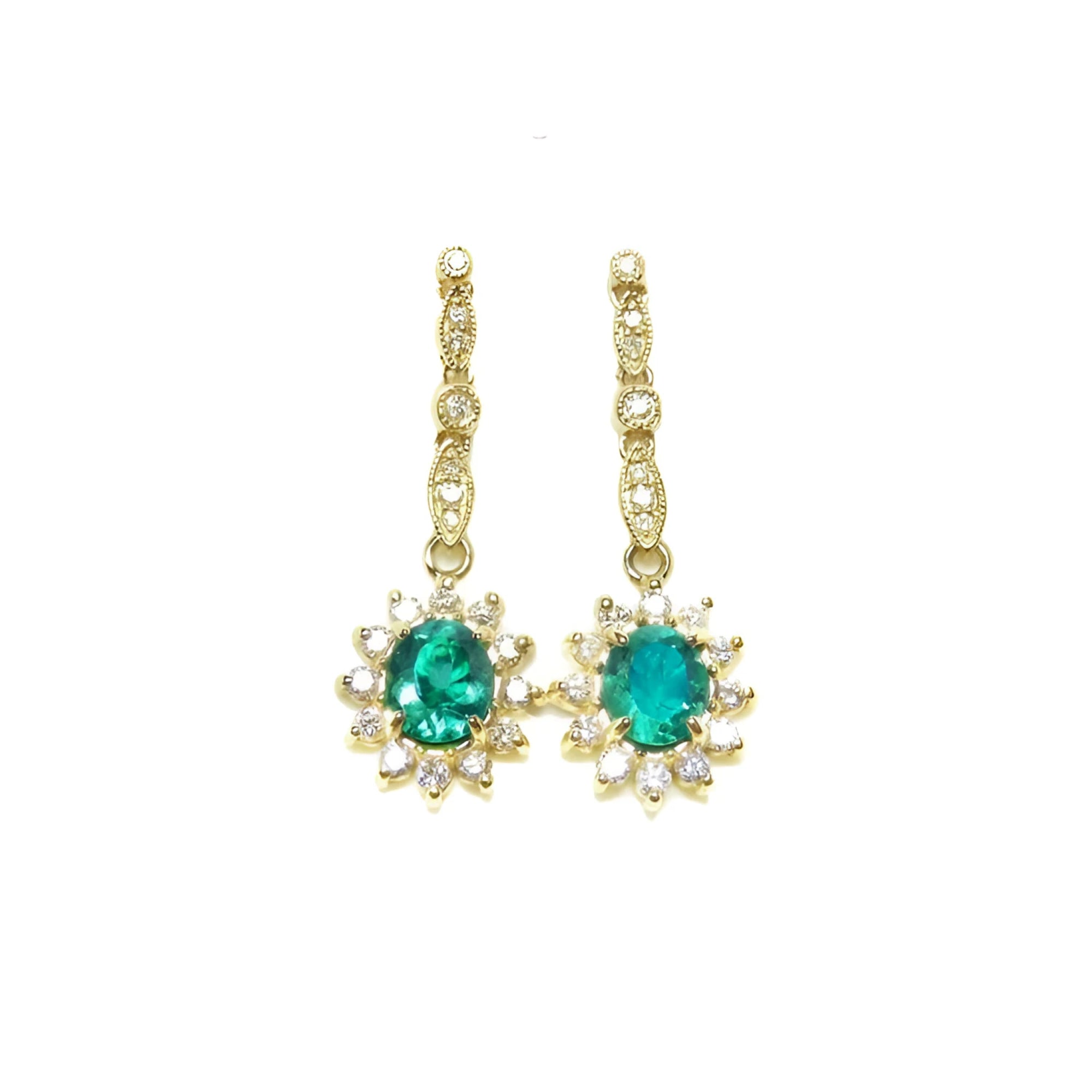 Oval emerald dangle earrings with halo diamonds in 14K yellow gold.
