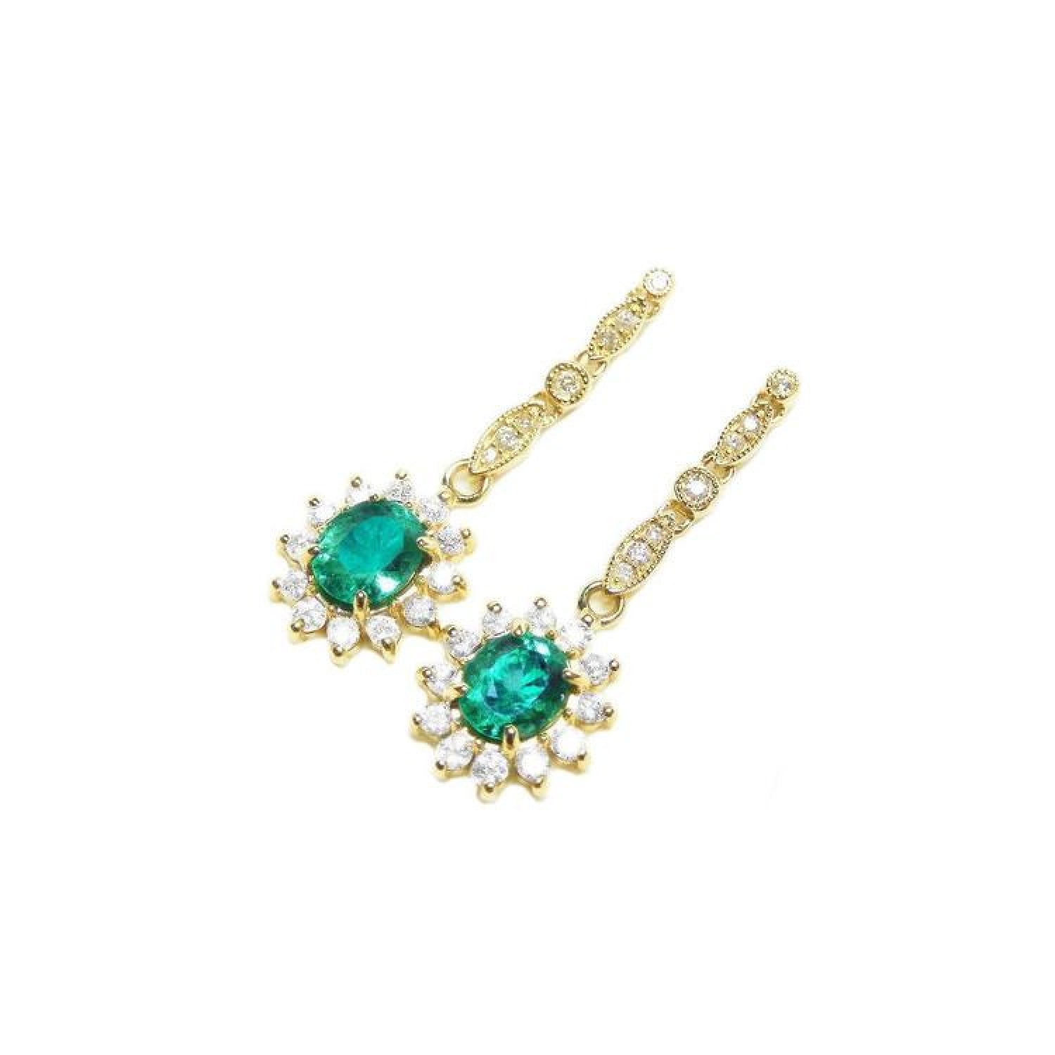 Oval emerald and halo diamond dangle earrings in 14K yellow gold.