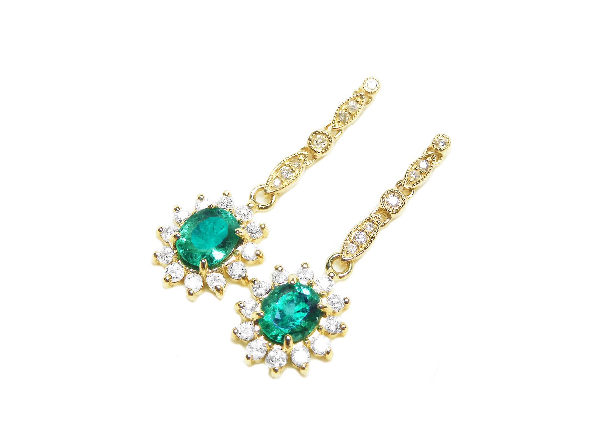 A left side position of a pair of earrings oval cut emerald dangle top side view