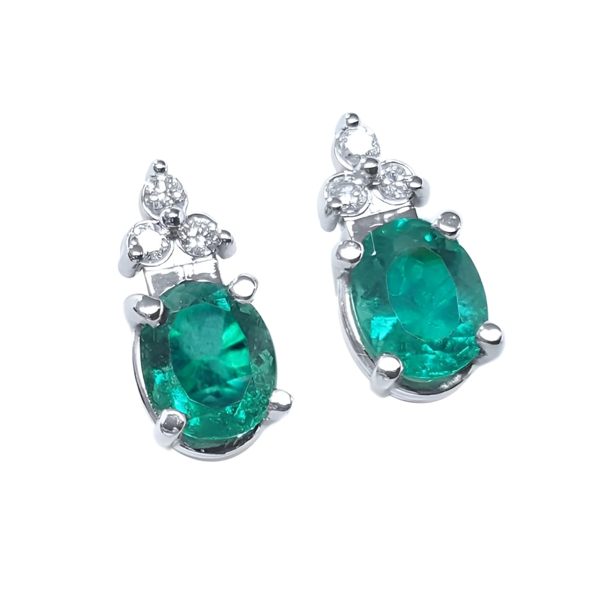 Pair of natural oval emerald earrings with diamond accents in 14k white gold, May birthstone.
