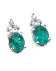 Pair of natural oval emerald earrings with diamond accents in 14k white gold, May birthstone.