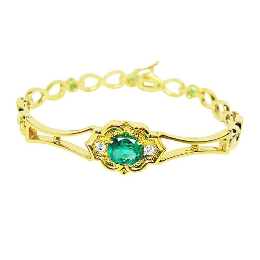 A 14k yellow gold bracelet with a Muzo mine natural colombian emerald oval cut. 
