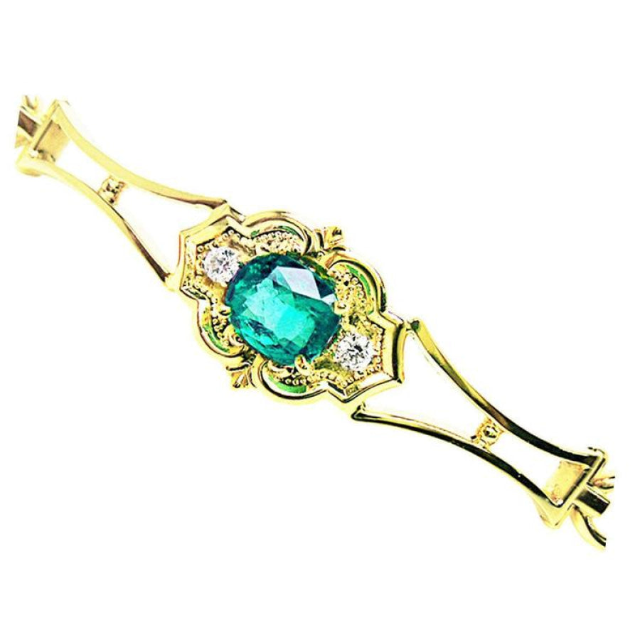 14K yellow gold bracelet with a central oval-cut natural emerald and two small round diamonds.