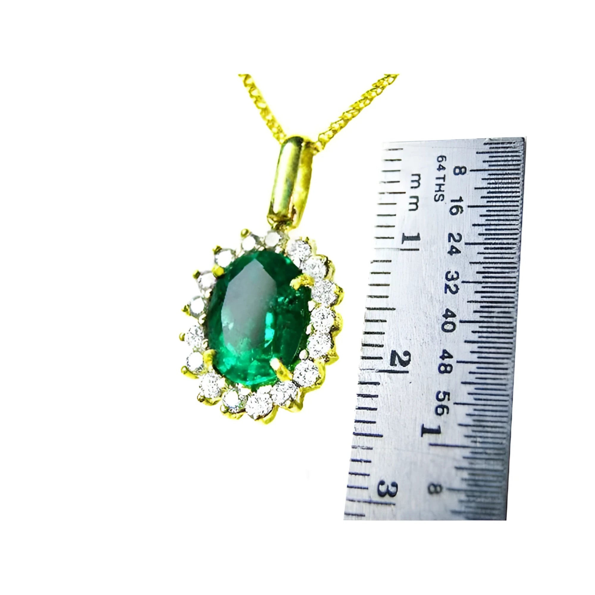 Oval natural emerald pendant with halo diamonds in 18K yellow gold, shown with a ruler for scale.