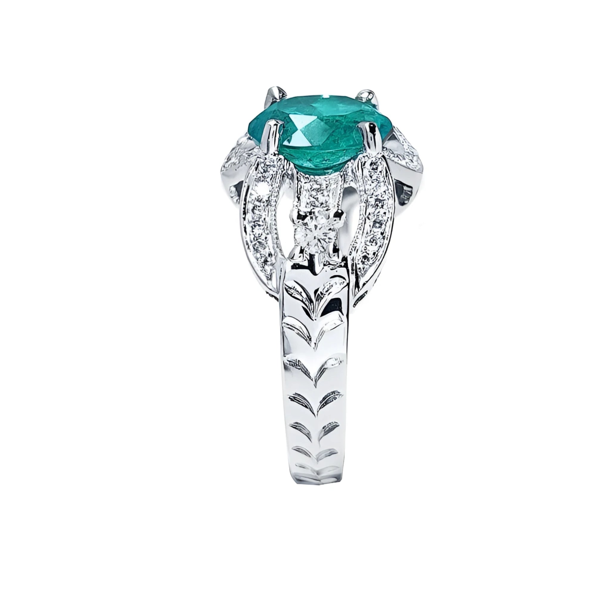 Natural oval emerald ring in 18K white gold with decorative bridal-style band and diamond accents.