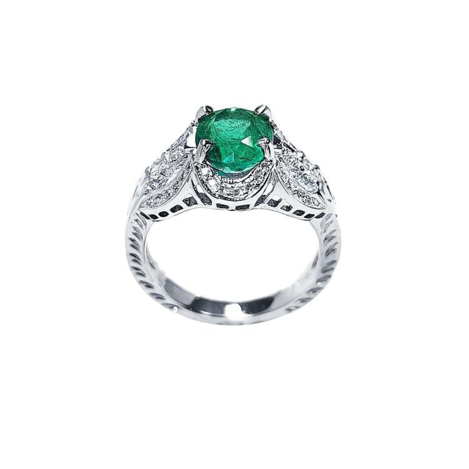 Natural oval emerald ring in 18K white gold with a decorative, bridal-style diamond band.