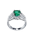 Natural oval emerald ring in 18K white gold with a decorative, bridal-style diamond band.