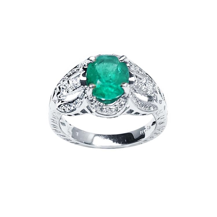 Oval cut natural colombian emerald ring with accent diamonds in 18k white gold.