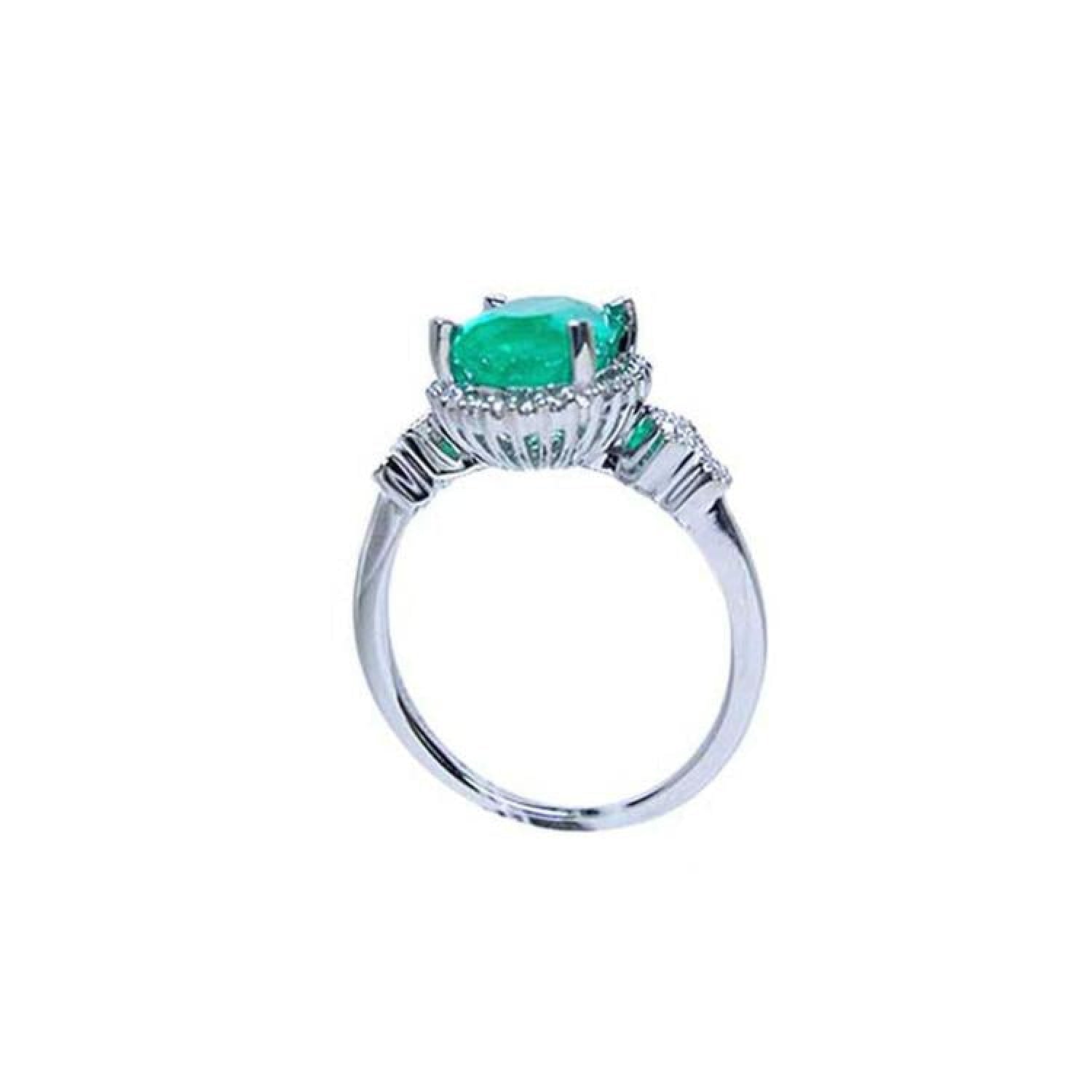 14K white gold halo ring with a 2.02 ct oval-cut deep green emerald and natural diamond accents.
