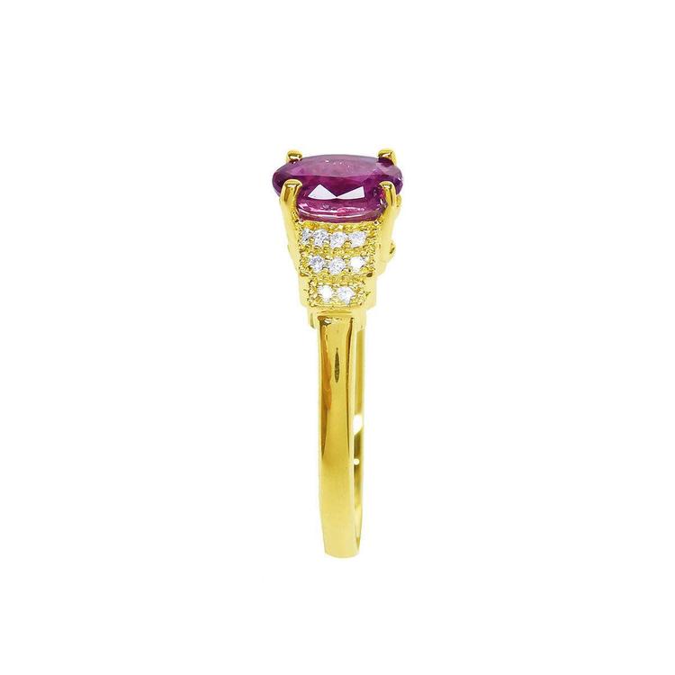 14k yellow gold ring with a deep red oval cut ruby and sparkling side diamonds.