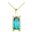 Baguette cut Colombian emerald pendant in 18K yellow gold with diamond accents.