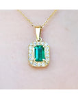 0.75 ct. GIA certified F1 Colombian emerald pendant with diamond halo in 18k yellow gold.