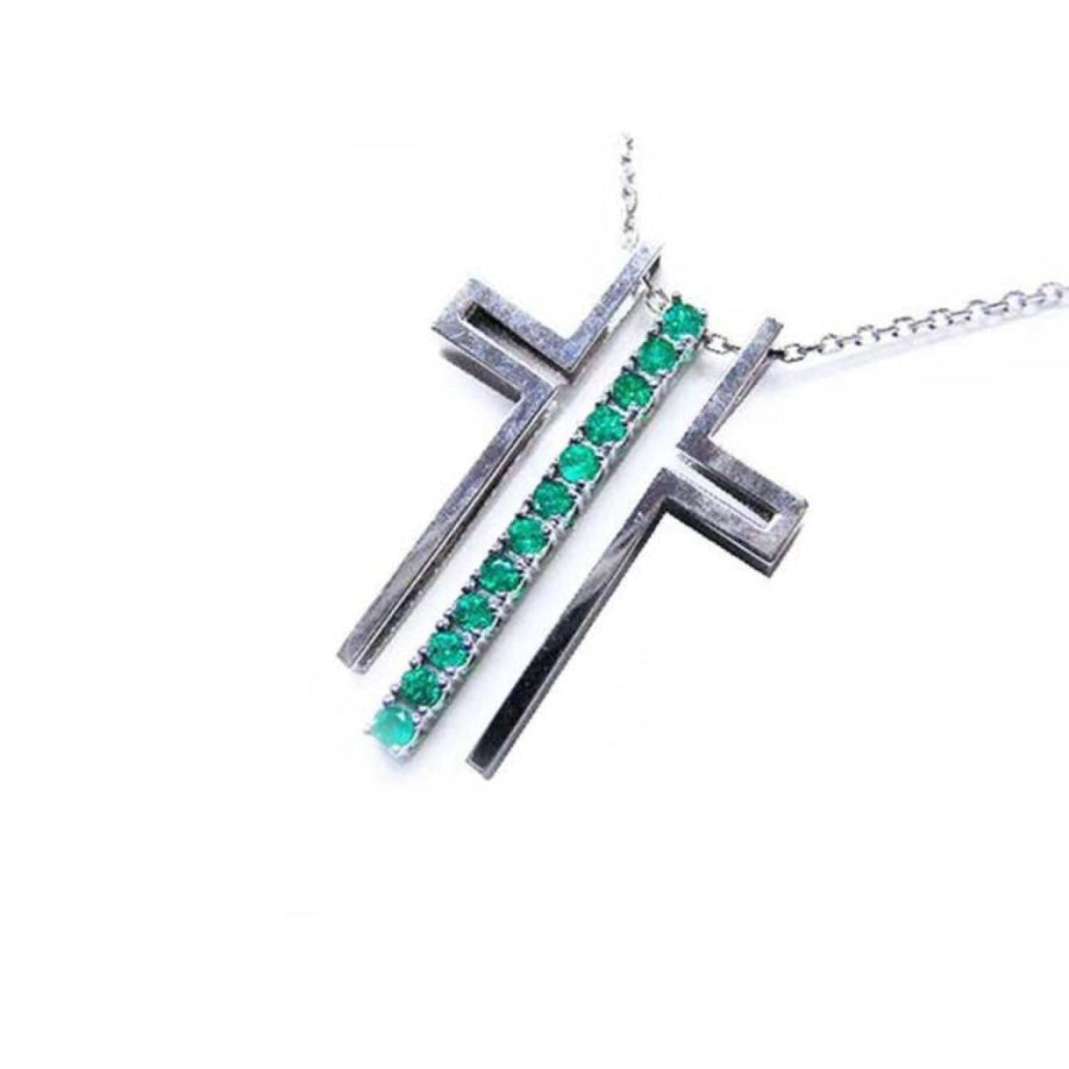 14K white gold cross pendant with prong-set round Colombian emeralds on a delicate chain.
