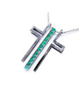 14K white gold cross pendant with prong-set round Colombian emeralds on a delicate chain.