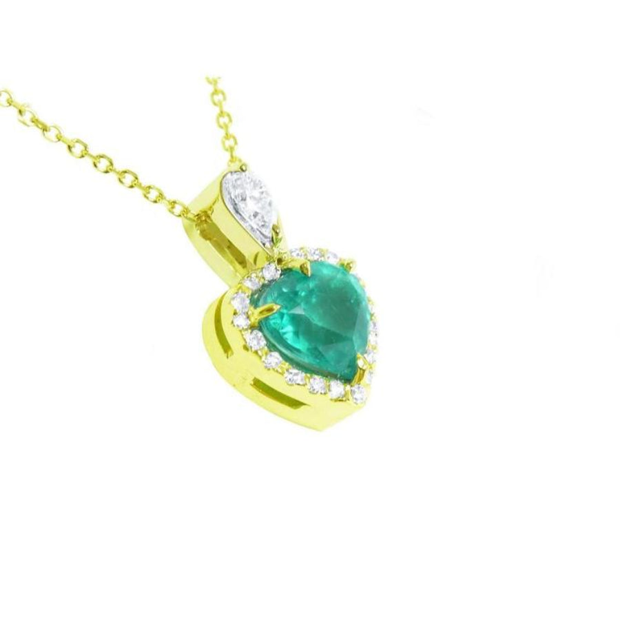 14K yellow gold heart pendant with a deep green emerald and diamond halo.