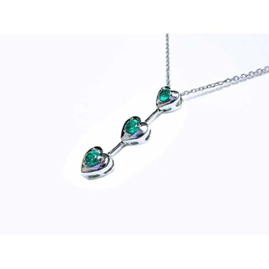 14K white gold heart journey pendant necklace with three round Colombian emeralds.