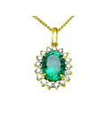Oval 3.01 ct. natural emerald pendant with halo diamonds in 18K yellow gold.