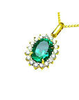 Oval natural colombian emerald pendant with halo diamonds in 18K yellow gold.