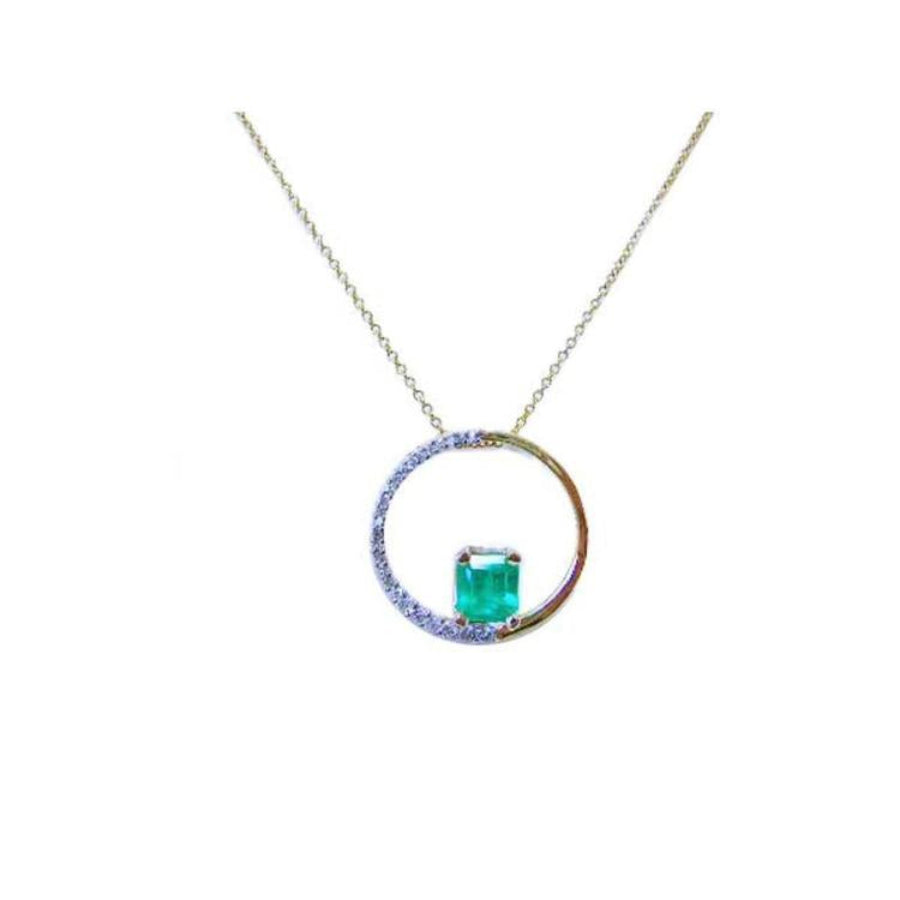 1.08 ct emerald pendant with natural diamonds and polished 14K gold "Circle of Life" design on a delicate chain.