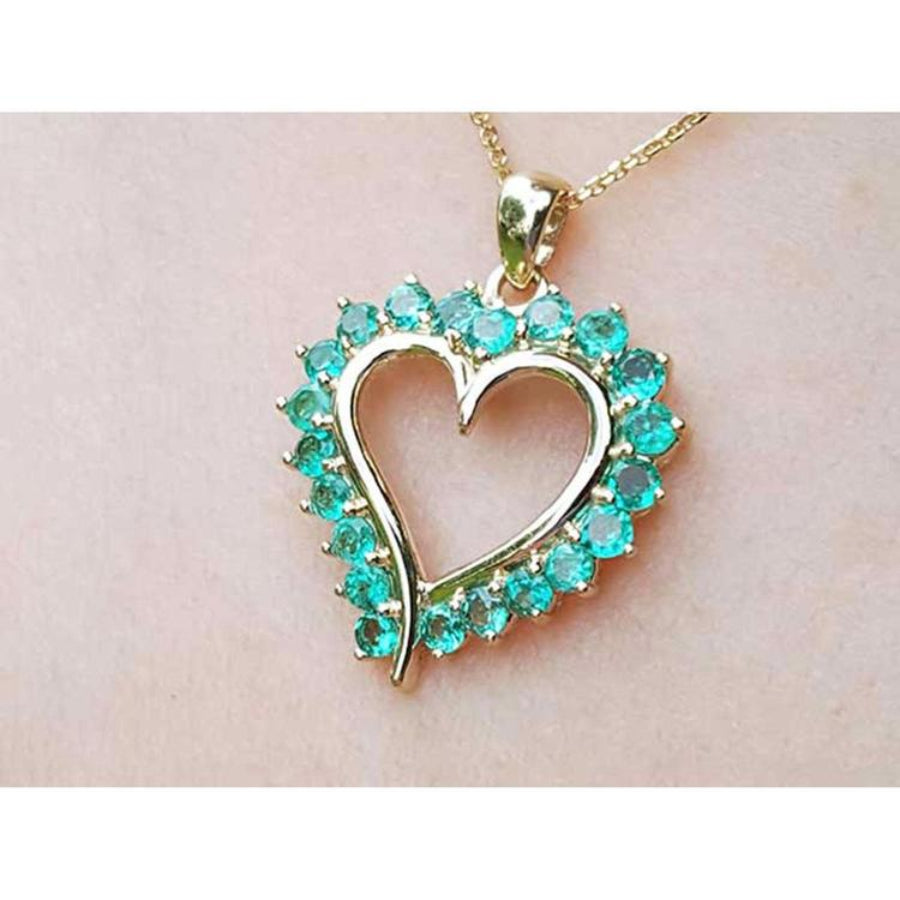 Heart-shaped pendant with round cut colombian emerald stones made of 14k yellow gold.