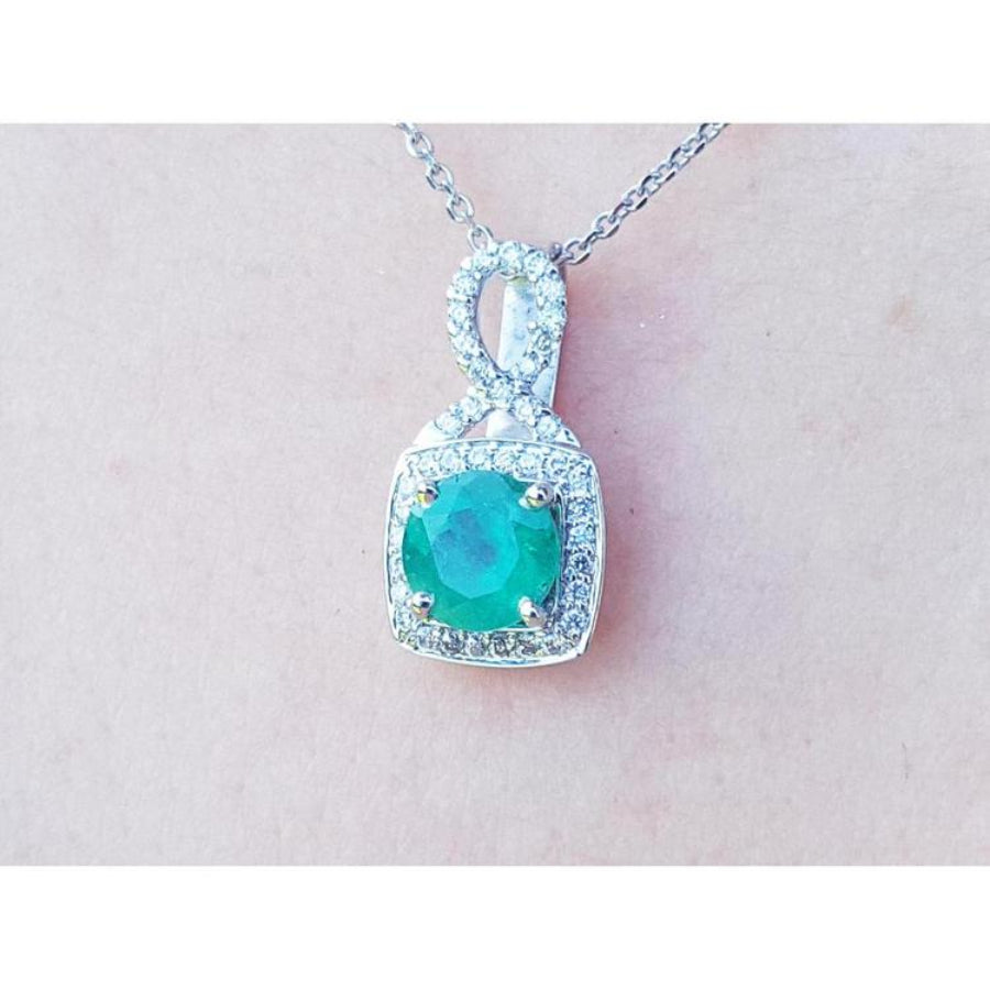 A 18k white gold pendant with a natural round cut colombian emerald from the Muzo mines.