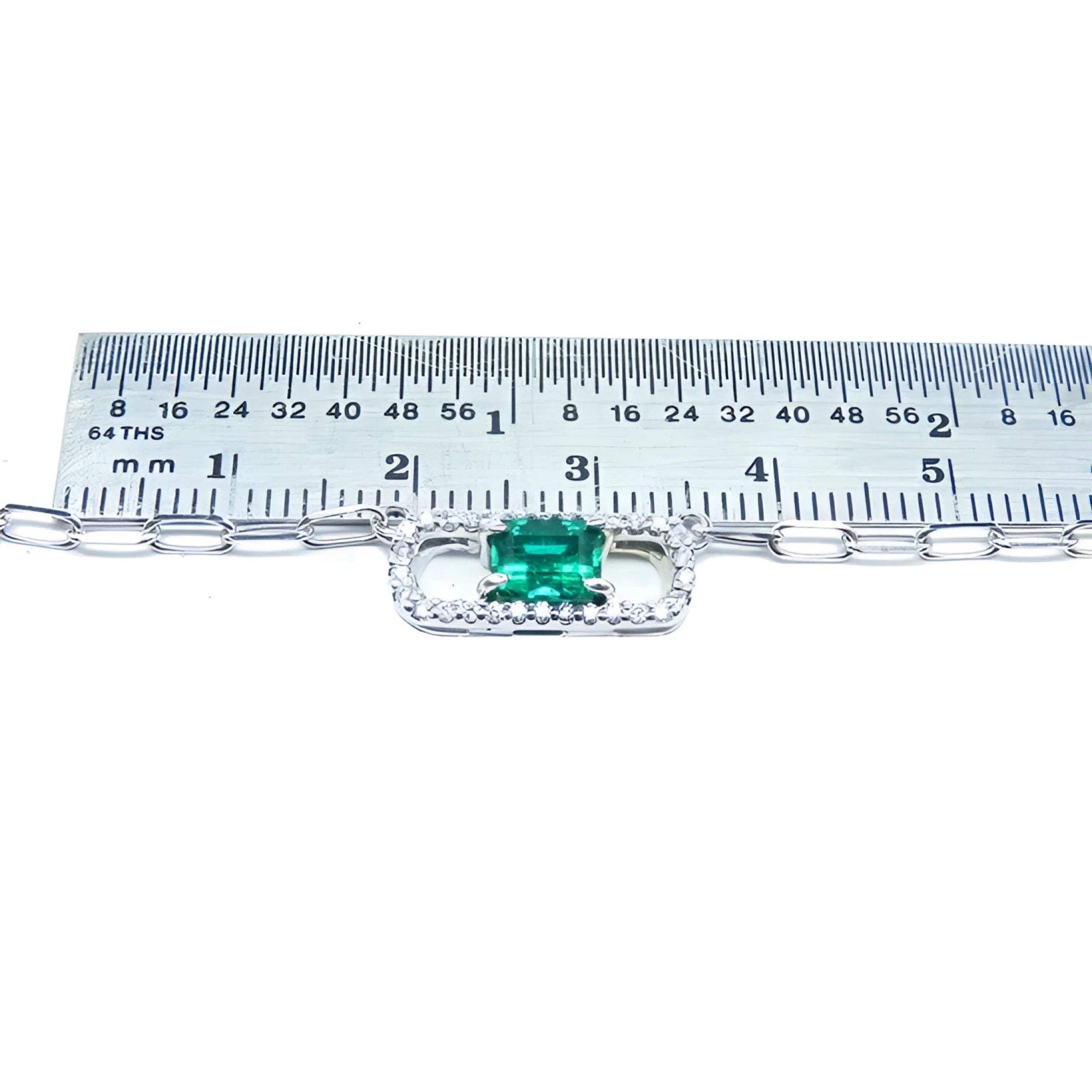 Emerald paper clip necklace with diamonds in 18K white gold, shown with ruler for scale.