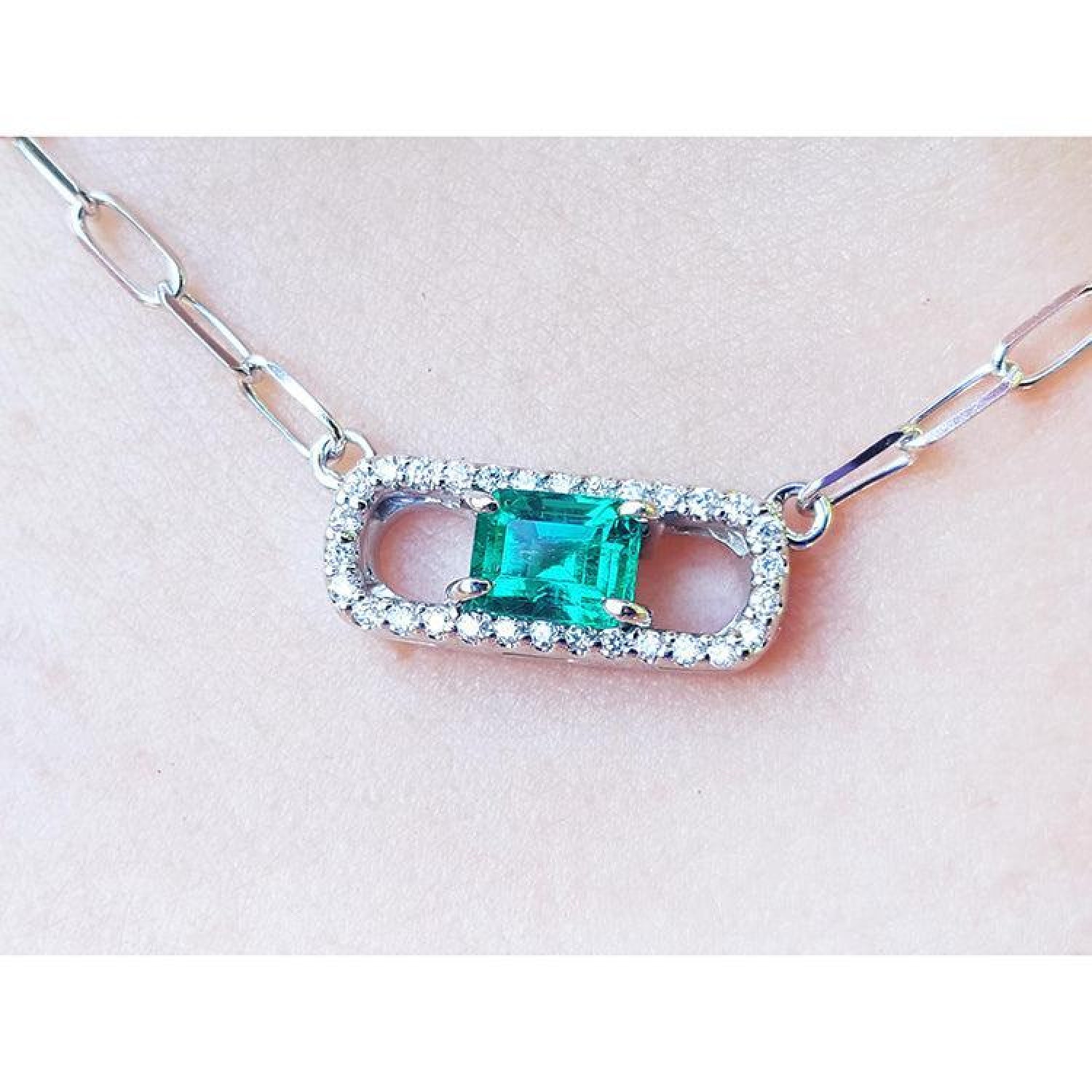 18K white gold paper clip necklace with a vibrant emerald and diamond pendant.