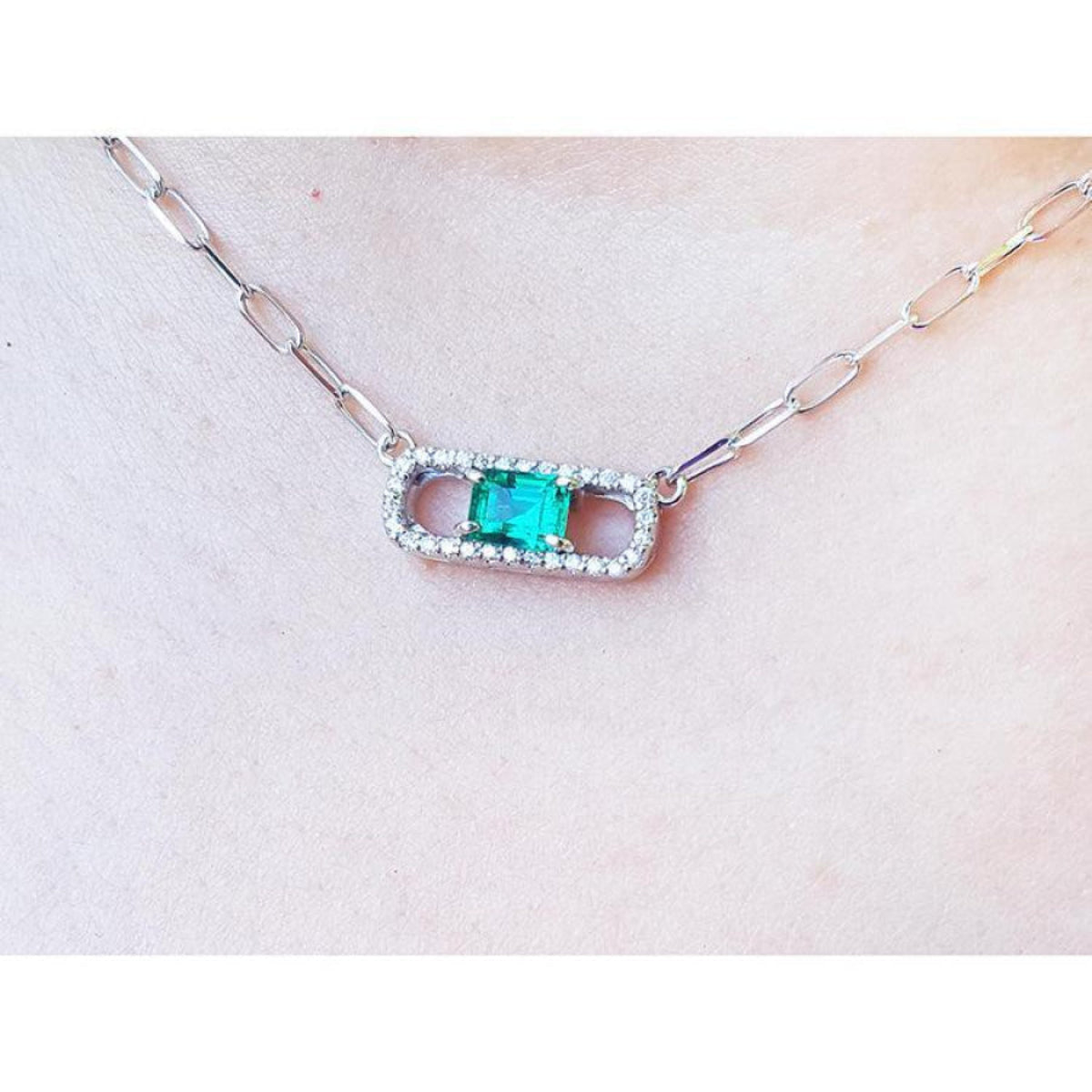 18K white gold paper clip necklace with a vibrant emerald and diamond-studded rectangular pendant.