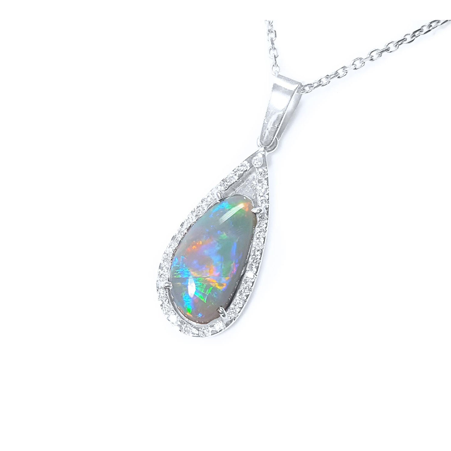 Teardrop-shaped solid Australian opal pendant in white gold and diamonds frame shows its left-side profile.