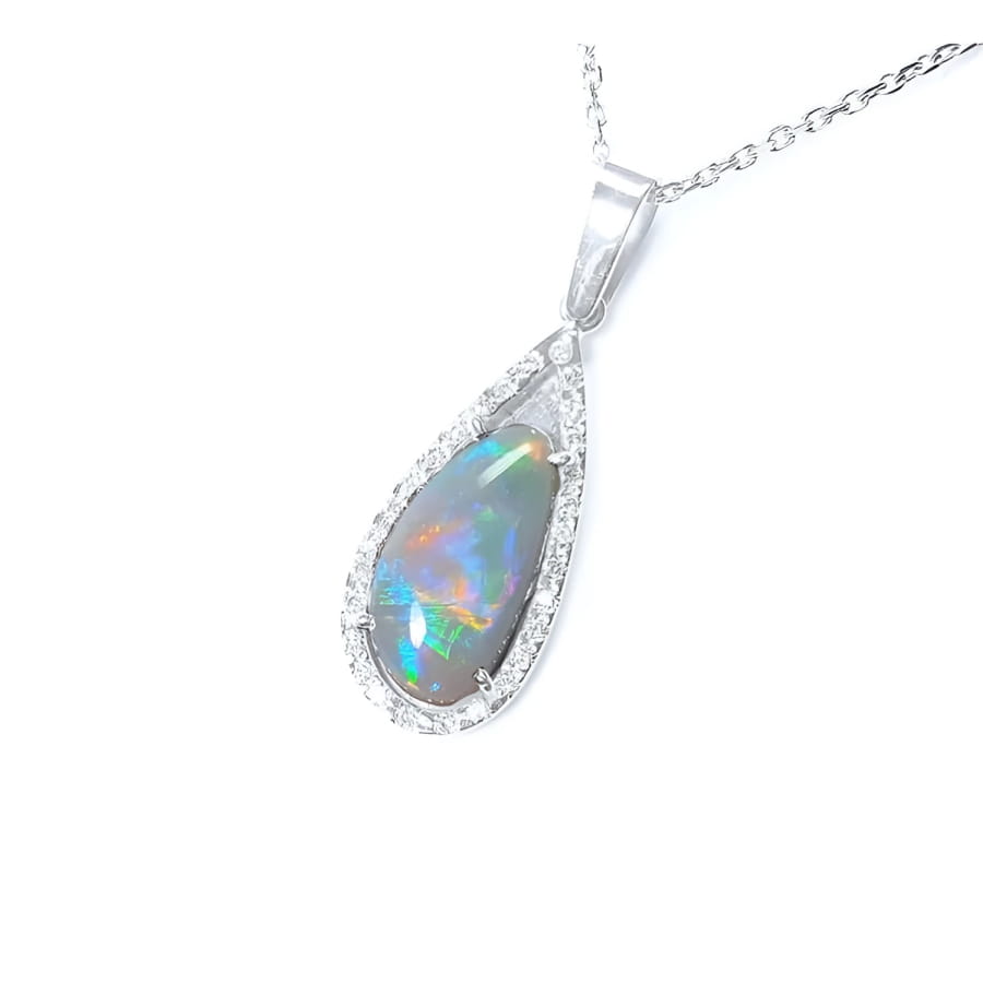 Pear-shaped Australian opal pendant with red, orange, blue, green play of color, halo diamonds, 18K white gold.