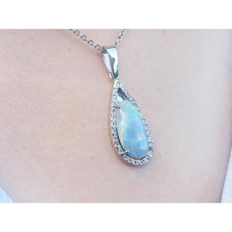 Pear-shaped Australian opal pendant with halo diamonds on an 18K white gold chain.