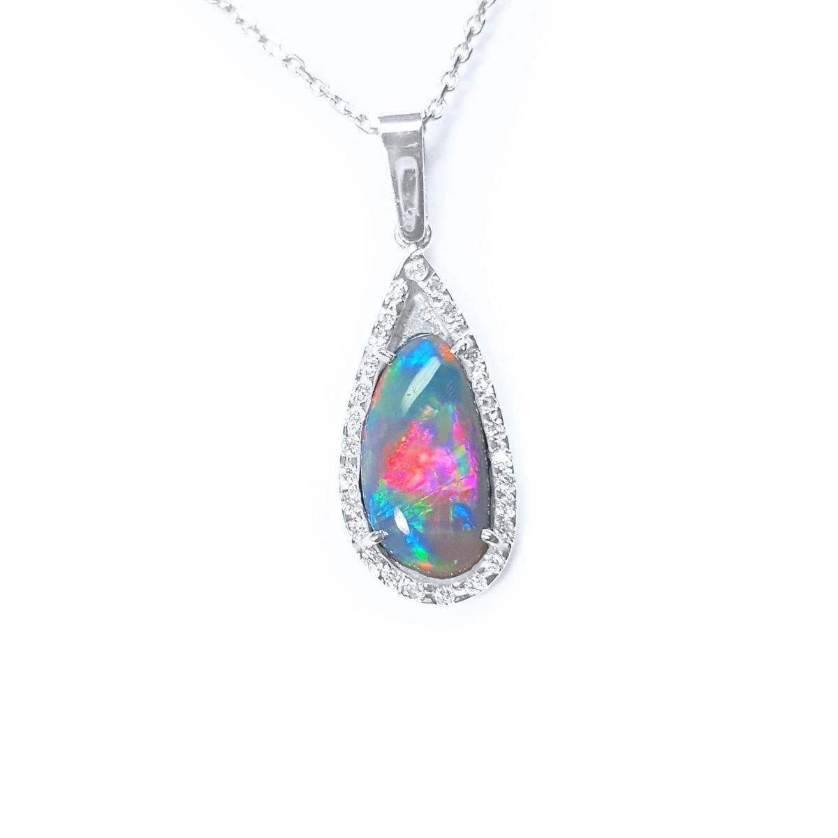 The topside of this opal pendant necklace with a halo diamond shows the topside impresive view.