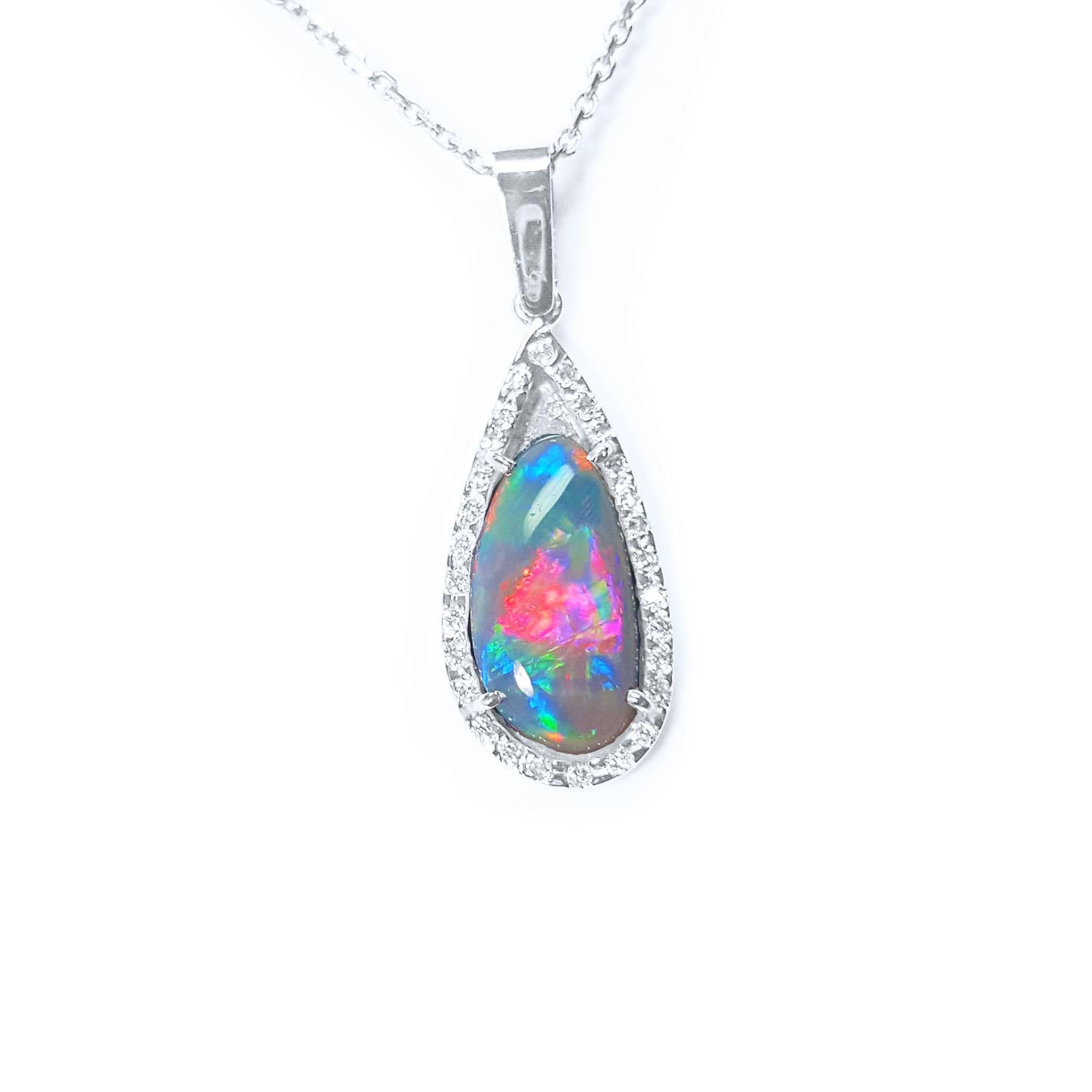 The topside of this opal pendant necklace with a halo diamond shows the topside impresive view.
