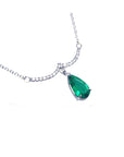 teardrop dangling emerald necklace natural Colombian emerald from a wavy central bar with diamonds pave set in 14k white gold
