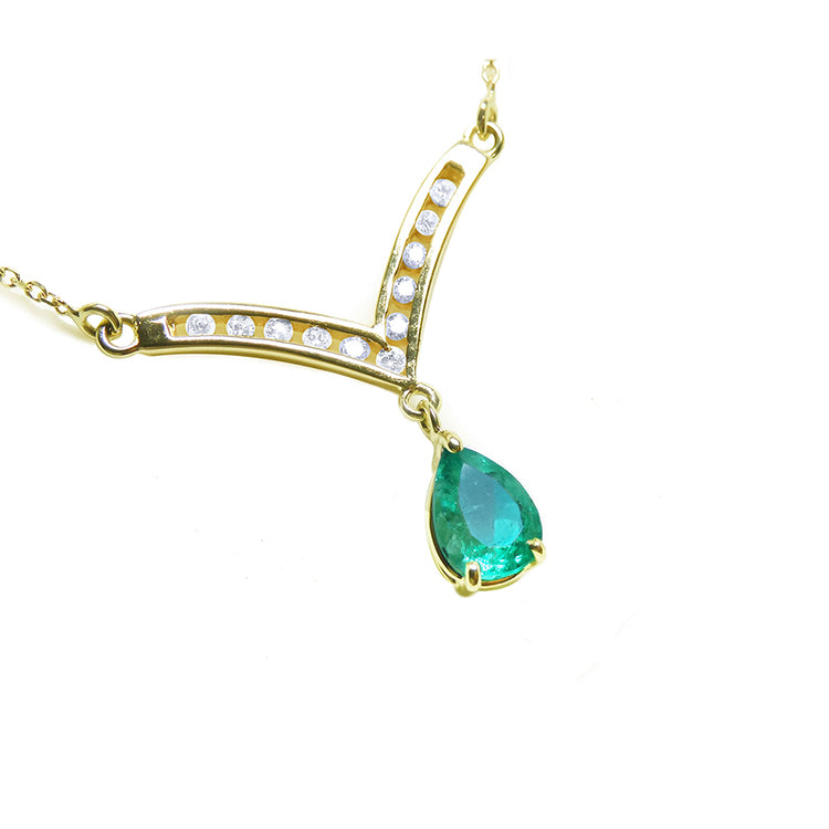 Tear drop natural emerald necklace: this Muzo Colombian gem is dangling from a channel set diamonds chevron design