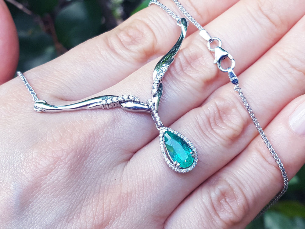Women&#39;s emerald jewelry necklace pear cut sourced from Muzo mines encircled by a halo diamond crafted in 14k white gold