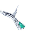 14K white gold necklace with a pear-shaped emerald pendant and diamond accents on a chevron design.